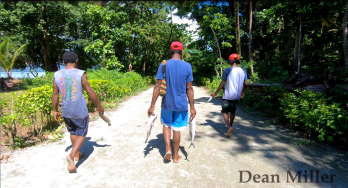 Fishers carry their catch to sell at the local market. Photo Credit: Dean Miller 2018